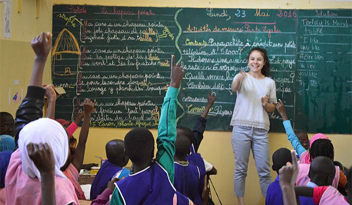 A Projects Abroad volunteer teacher leads an English class at a school in Senegal
